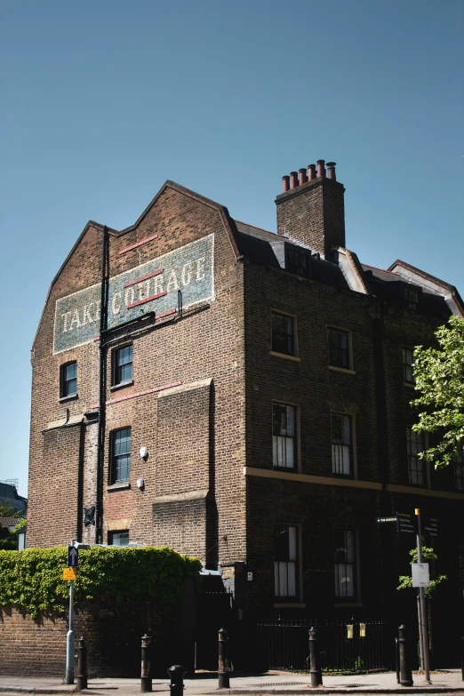 a large red brick building is on the corner