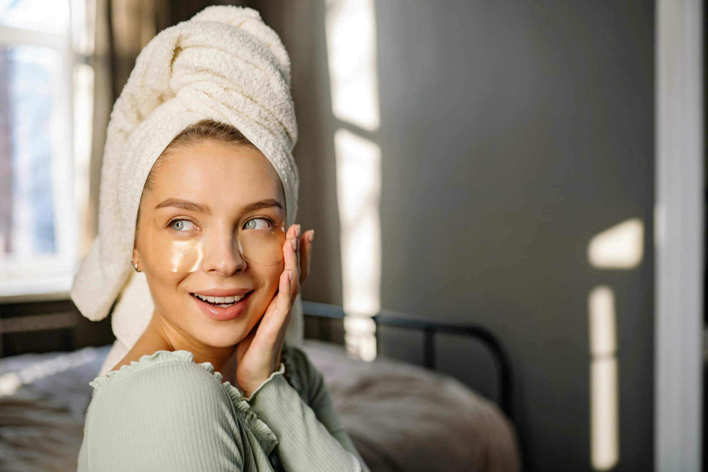 a woman is smiling with a towel on her head