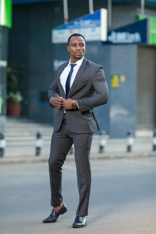 a man in business attire walking across the street