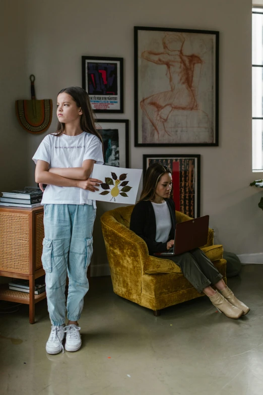 two young women with laptops are in an office