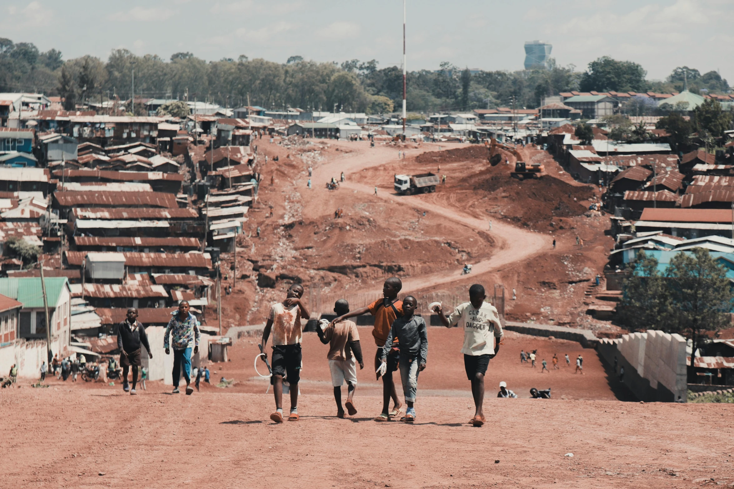 a group of people walking in the dirt