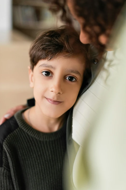 a close up of a little boy talking on the phone