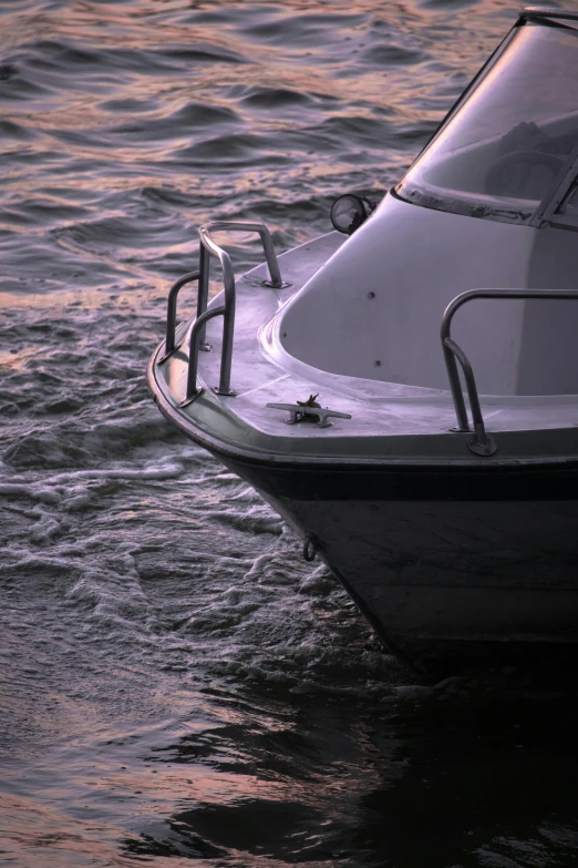 the boat has a metal railing and a seat