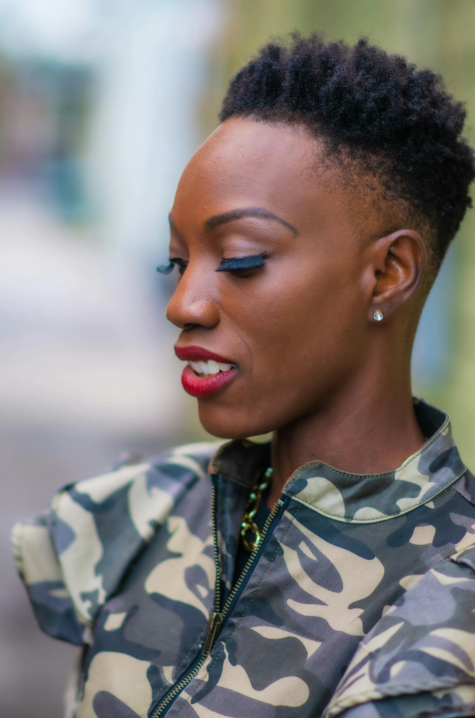 a woman with red lipstick stands looking down