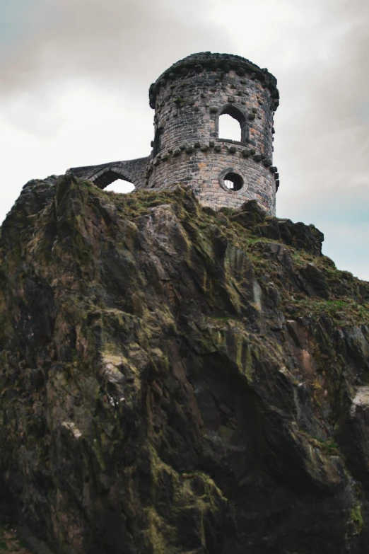 a large rock tower on the side of a hill