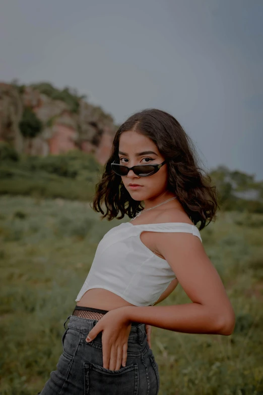 an image of a woman posing with her sunglasses on