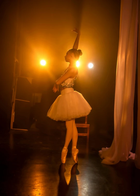 a woman in white is performing on stage