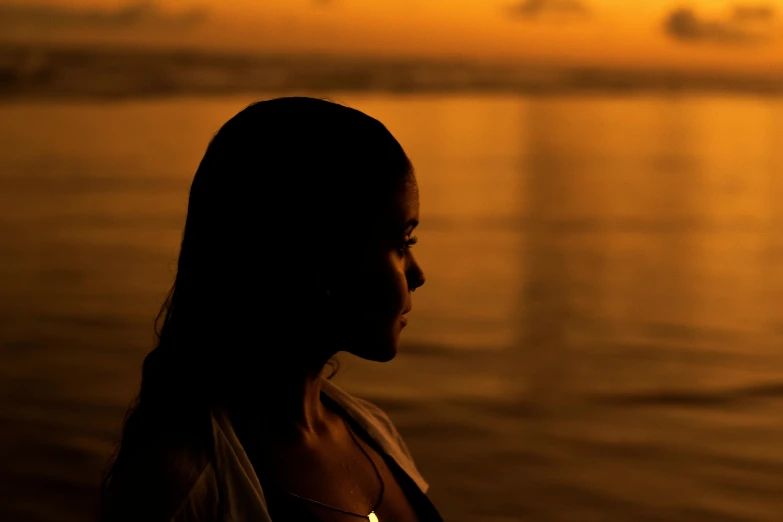 a woman standing next to a body of water