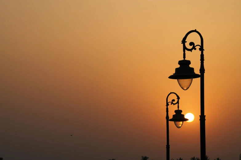 a street lamp with a very pretty sky in the background