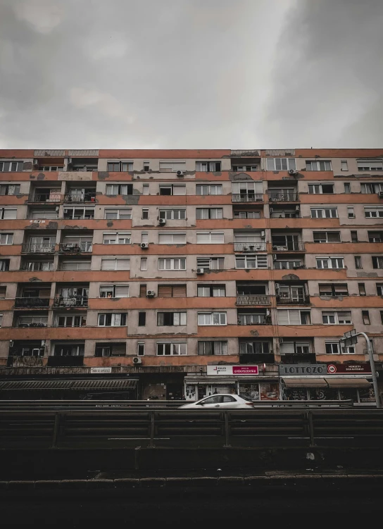 a very tall building sitting in the middle of a highway