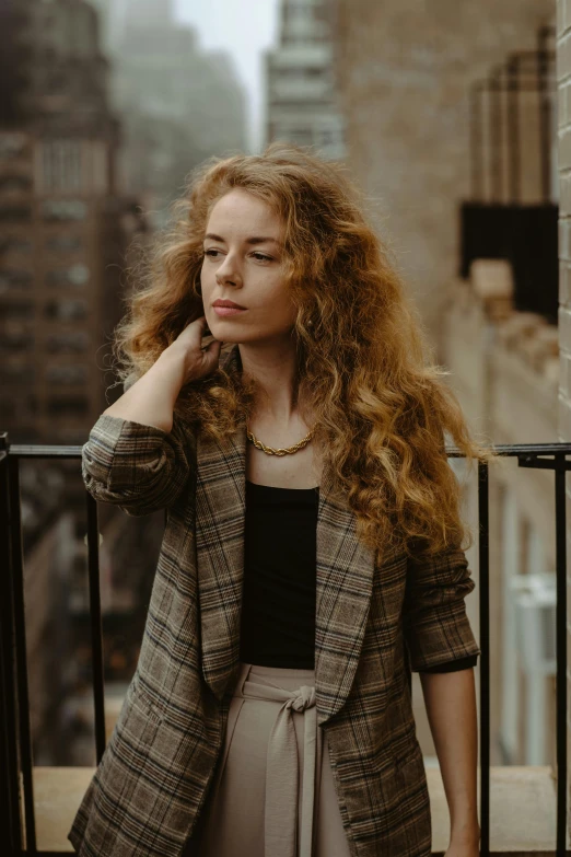 woman with long red hair in urban setting