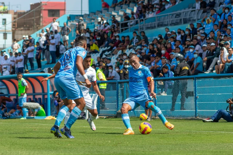 a group of young men kicking around a soccer ball