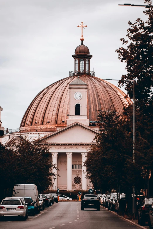 a big building with a dome near trees