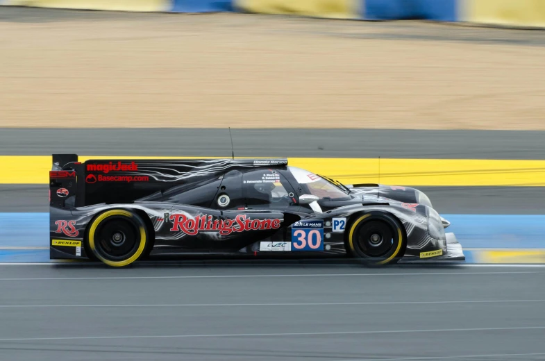 a very fast moving car racing along the track