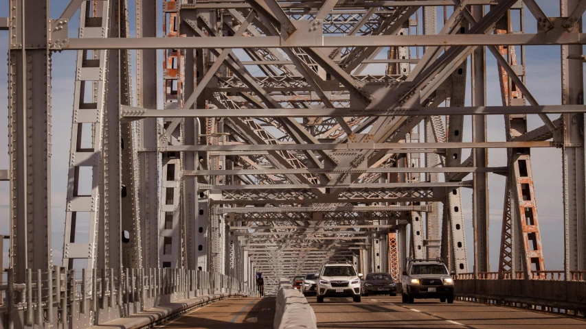 several cars on a bridge driving on it