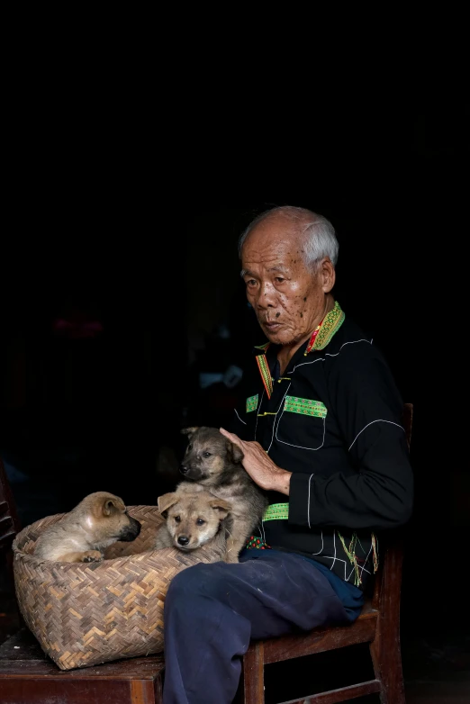 an old man is holding a large dog