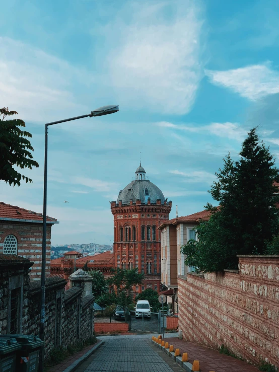 the city street has cobblestone streets and tall buildings