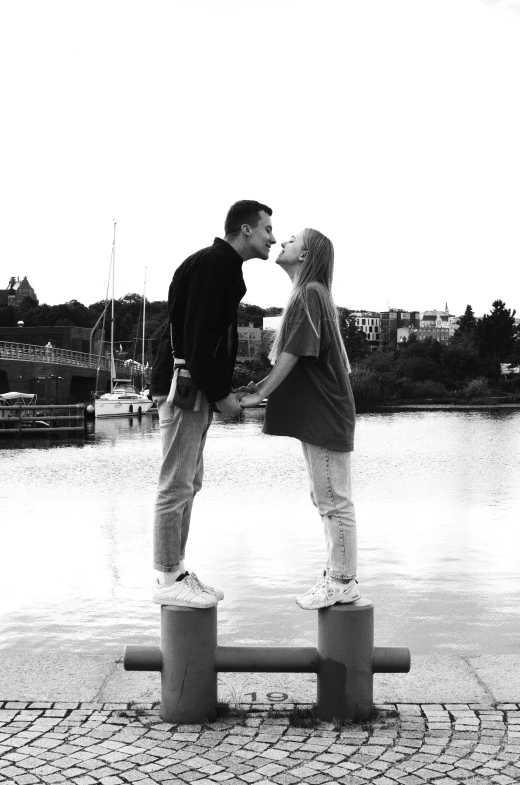 there are two young men standing on pillars kissing each other