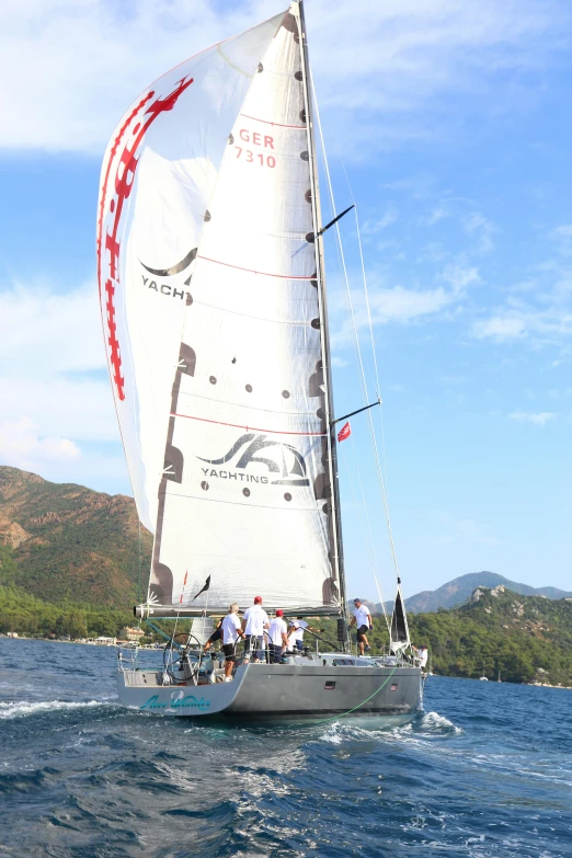 a sail boat with a flag on it