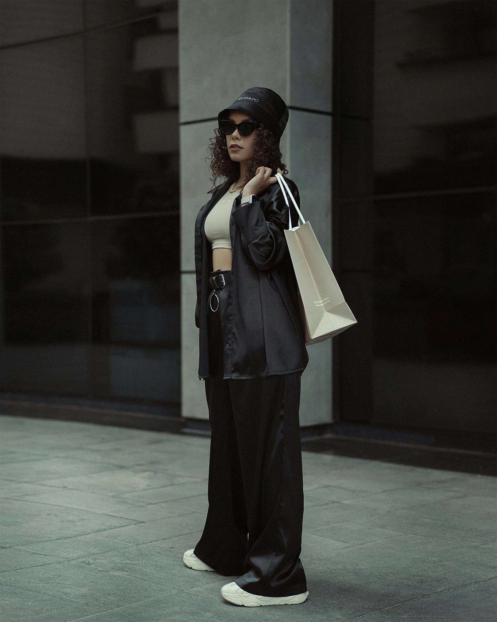 woman in black with paper bag and shoes