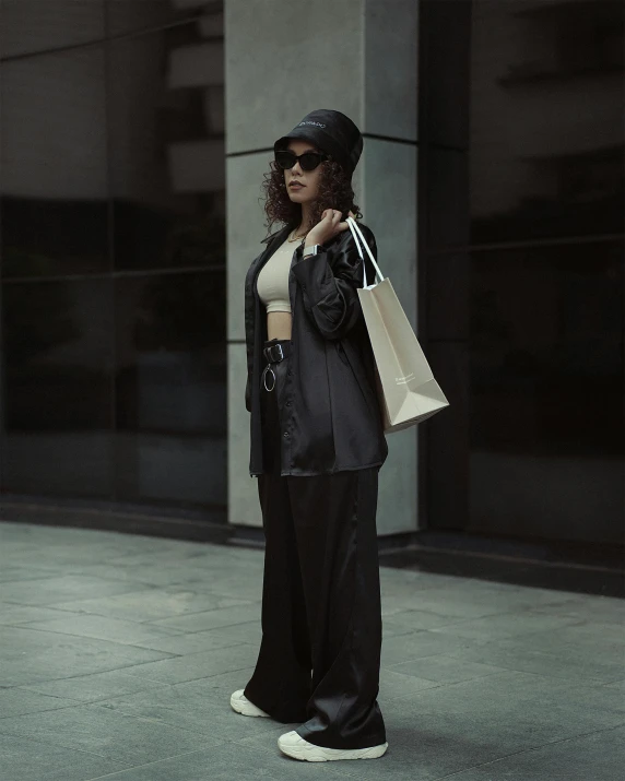 woman in black with paper bag and shoes