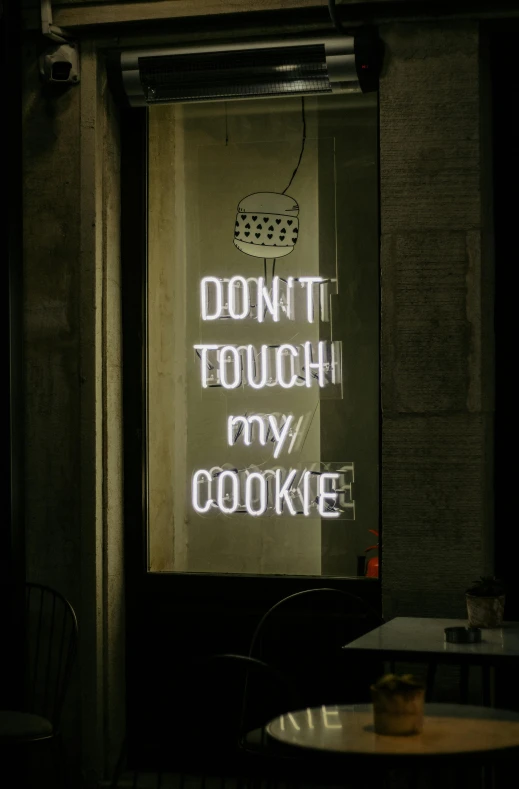 a lighted display on a window says don't touch my cookie