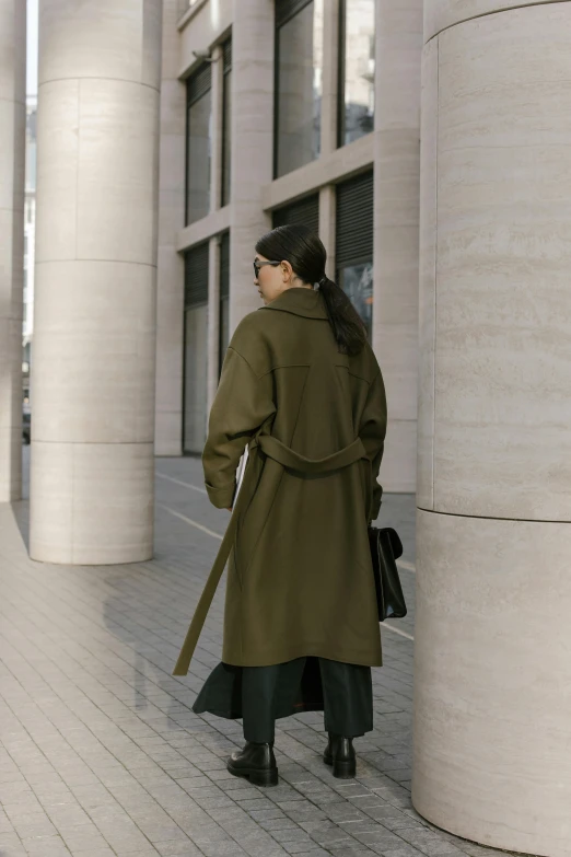 a person with a coat and hat is standing outside