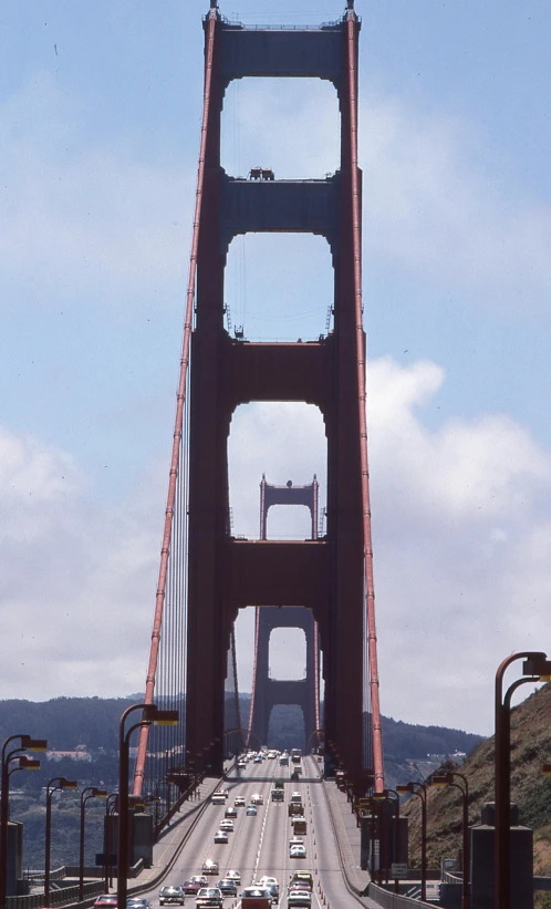 a group of cars are driving across the golden gate bridge