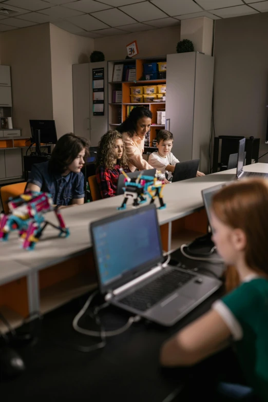 children sitting at desks looking at laptop computers