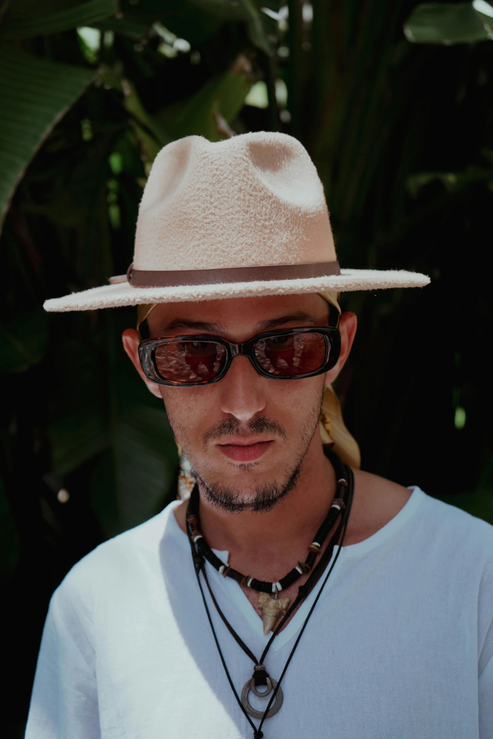 a man wearing shades and a white hat