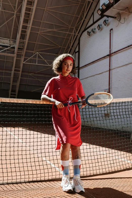 a woman holding a tennis racquet on a court