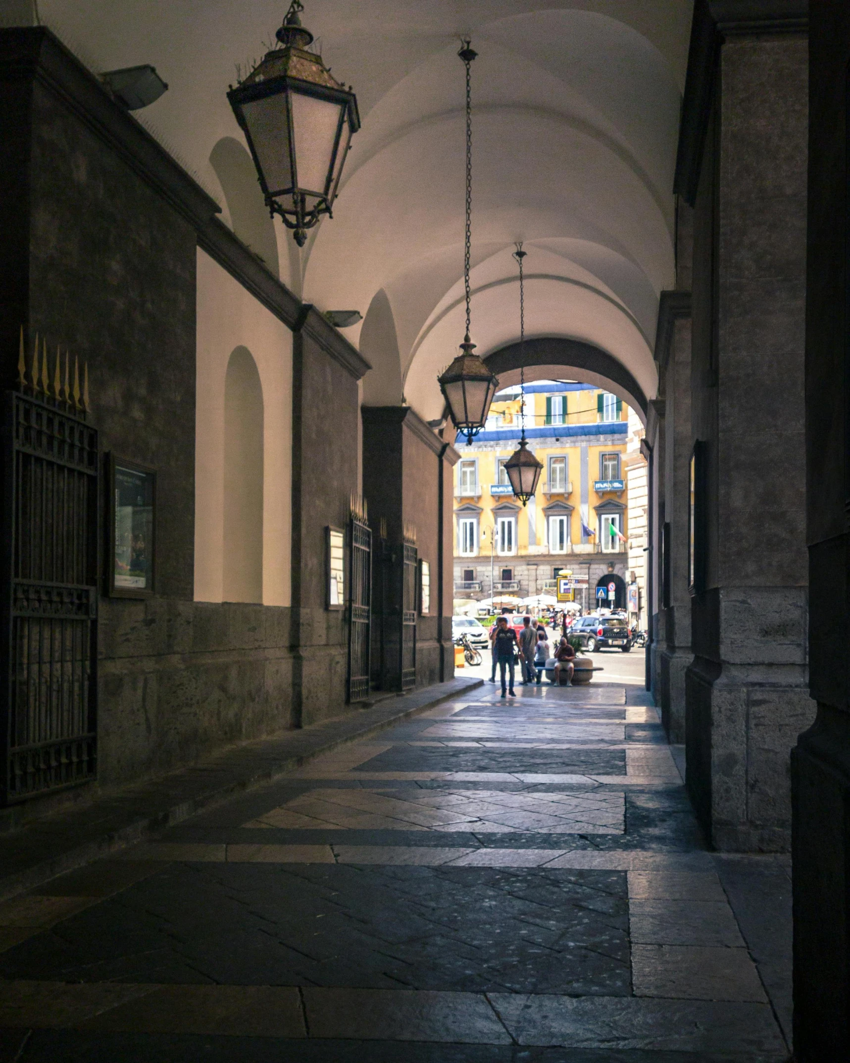 an empty hallway that has an arched archway