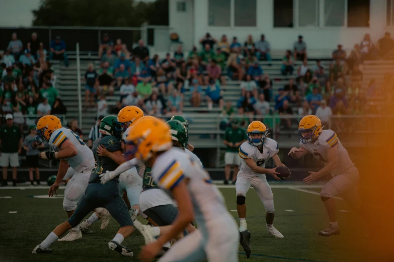 a football game in progress with players on the field and in front