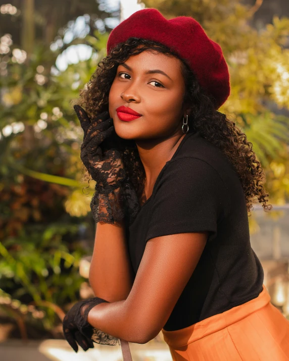 the woman wearing an orange skirt is wearing a red hat