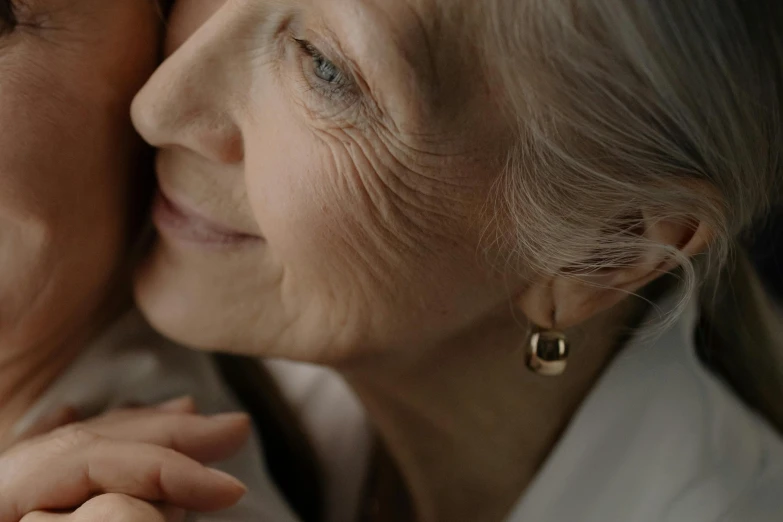 two women are looking at each other with one holding the other