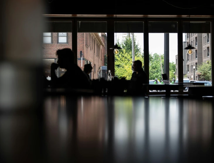 a glass table with people in silhouette at night