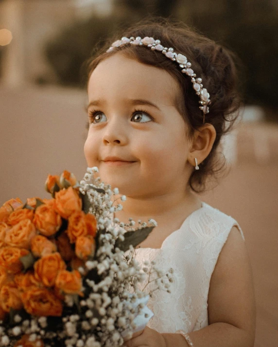 an image of a little girl holding a bouquet of flowers