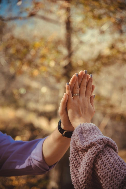 an image of two people putting their hands together