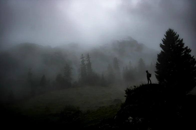 a person on a hill with a backpack walking up