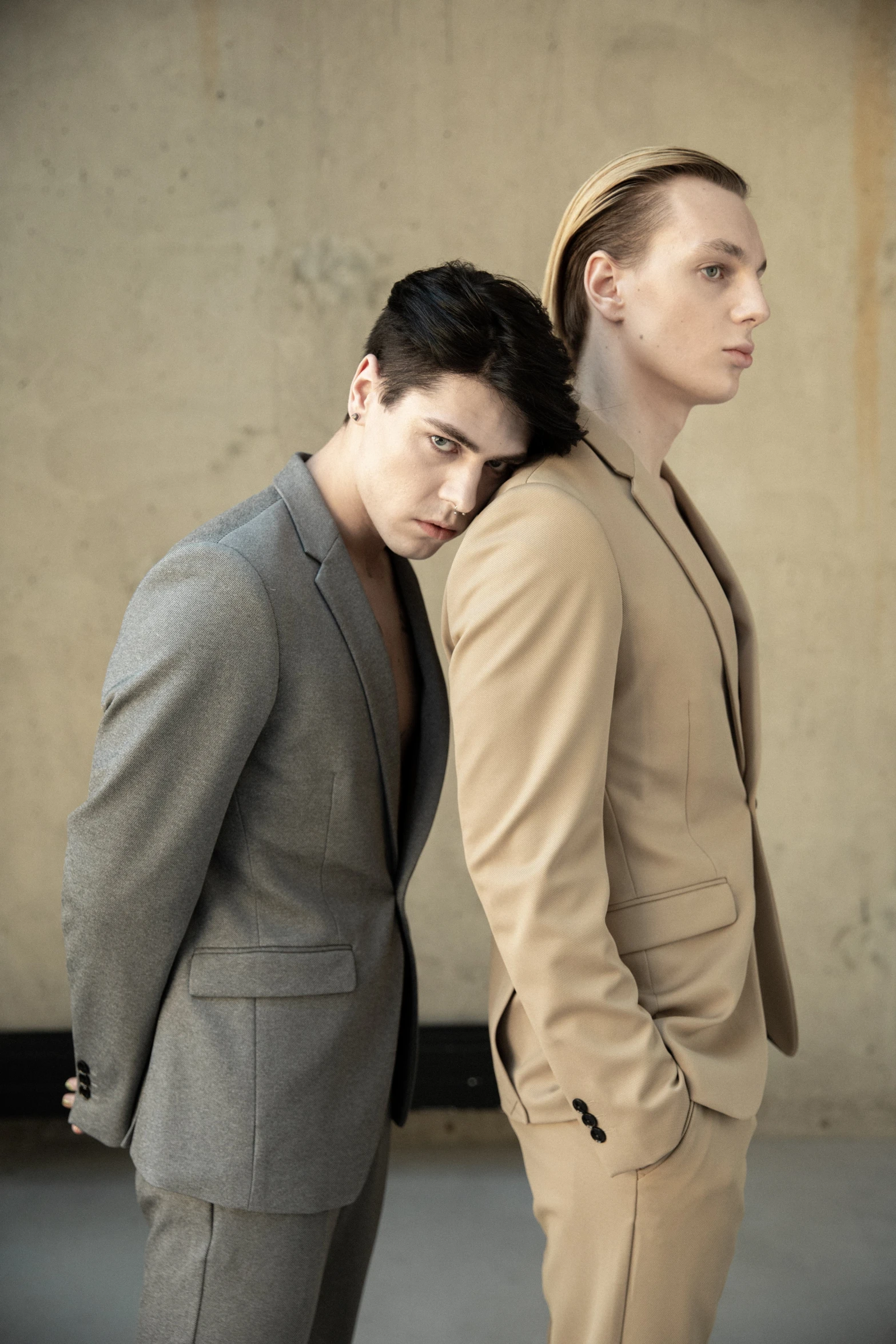 two young men in suits are posing for a pograph