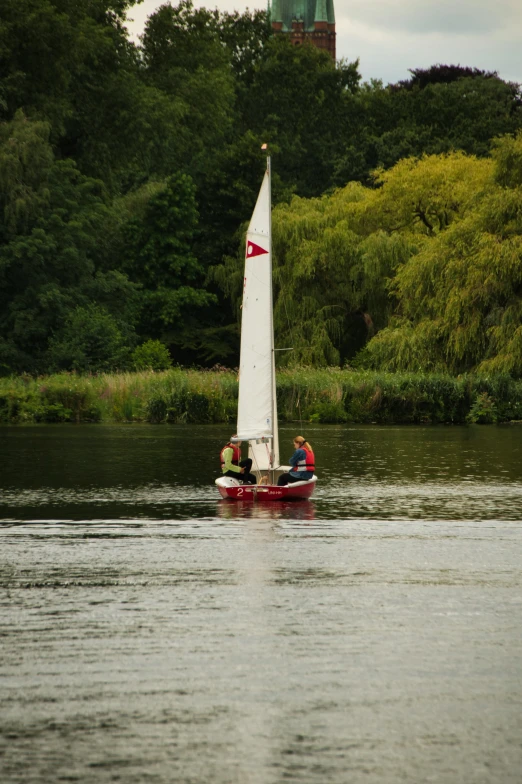 a white sail boat in the water