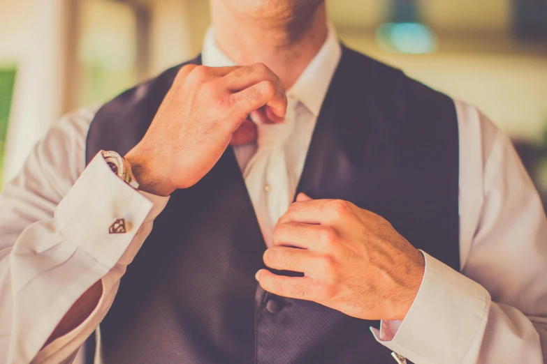 a man in a vest and bow tie