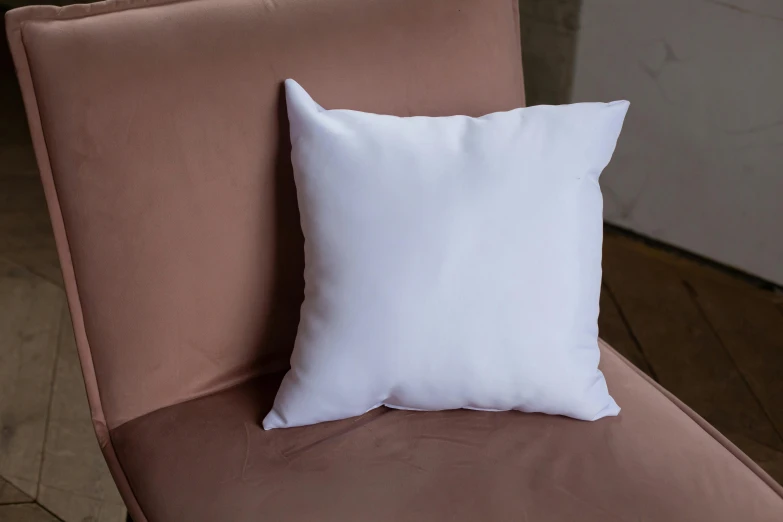 a white pillow is shown on the back of a brown chair