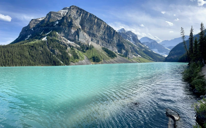 the water in the mountain lake is clear and blue