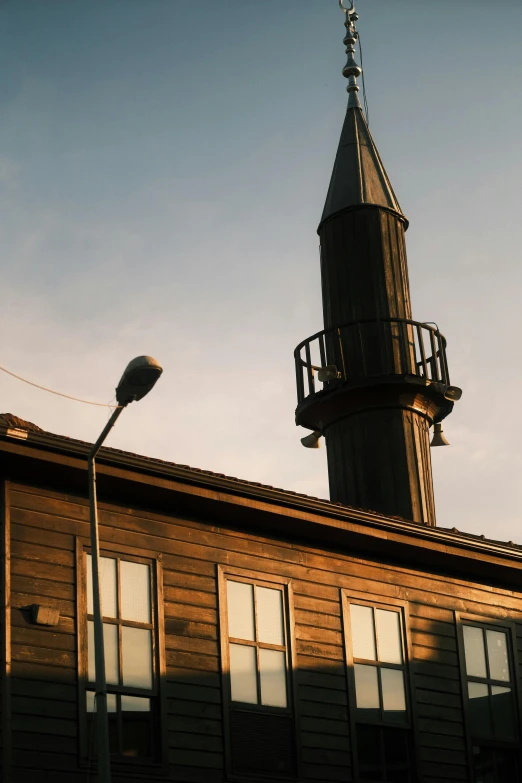 there is a tall brown building with a clock tower