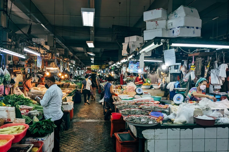 a food market with lots of people at tables