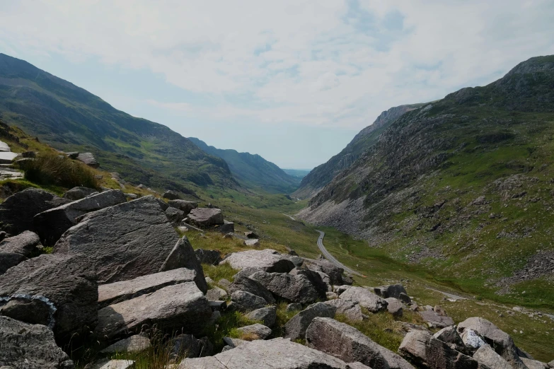 a valley with rocks and plants on the side