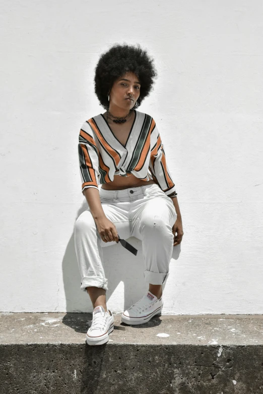 a black girl sitting on a step with an umbrella