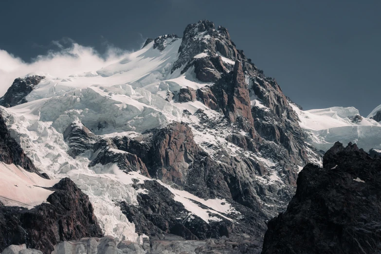 some very big mountains with a pretty snow capped peak