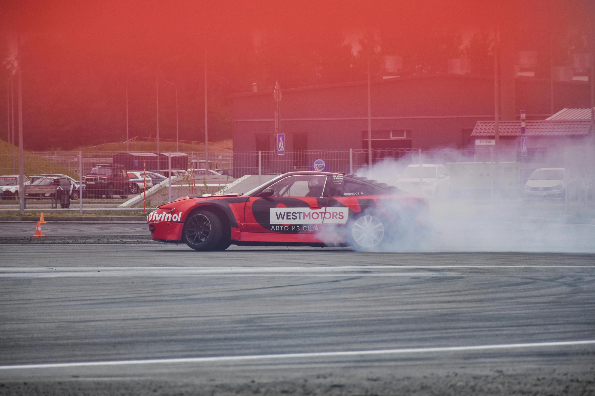 a car doing tricks with its tires out on the pavement